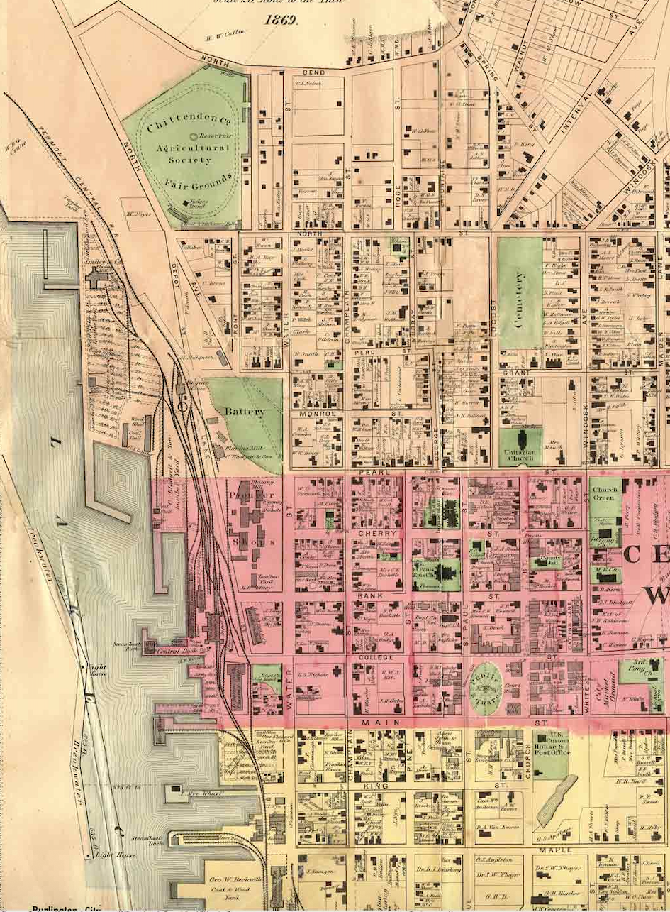 Hand-coloured 1869 survey map of Burlington, Vermont, showing the Lake Champlain waterfront, rail lines and named city blocks.