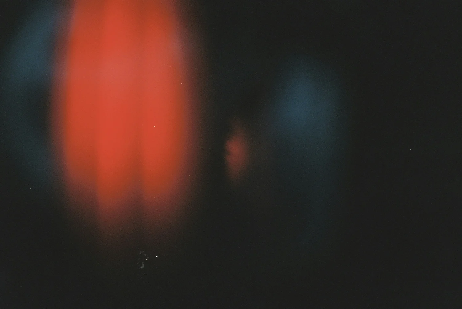 Deep red glow spreading through darkness.